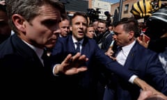 Macron with arm outstretched