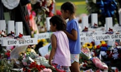 Children pay their respects in front of the memorial at Robb elementary school