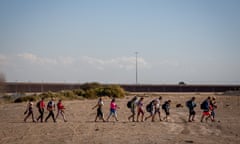 People arrive at the border between Mexico and the US on 13 December. 