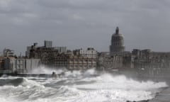 Waves break over Havana’s seaside promenade.