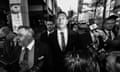 Black and white photo of Israel Folau walking outside surrounded by media