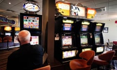 A man plays a pokie machine at a club in Altona, Melbourne on Tuesday, Jan. 24, 2012. (AAP Image/Paul Jeffers) NO ARCHIVING
