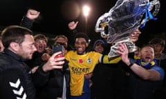 Shaun Jeffers celebrates with St Albans fans on the pitch after victory at Clarence Park.