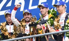 Fernando Alonso, second left, Sebastien Buemi and Kazuki Nakajima (right) celebrate on podium after winning the 87th edition of the Le Mans 24 Hours race.