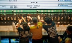 Bar staff serve drinks at a launch event for the BrewDog Waterloo in London.