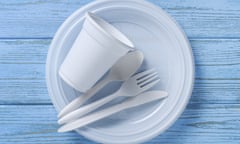 Disposable tableware and cutlery on blue wooden table