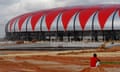 Construction workers are seen near Luanda Stadium, one of the stadiums that will host the 2010 African Cup of Nations soccer tournament, on the outskirts of Luanda, Angola, Monday, Dec. 14, 2009. Angola will host the African Cup of Nations soccer tournament from Jan. 10, 2010 to Jan. 31, 2010. (AP Photo/Schalk van Zuydam)