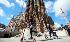 Two girls play in front of the Sagrada Familia in Barcelona