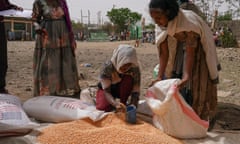 An aid worker distributes lentils in Mek’ele, the capital of Tigray.