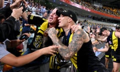 Dustin Martin of the Tigers celebrates victory with the fans after the 2020 AFL Grand Final match between the Richmond Tigers and the Geelong Cats