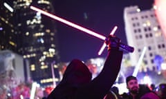 A Star Wars fan dressed as Kylo Ren raises his lightsaber during Lightsaber Battle LA in Pershing Square in downtown Los Angeles, California on December 18, 2015. "Star Wars: The Force Awakens" smashed the opening night record in the United States and Canada positioning itself to become one of the biggest grossing movies ever, industry experts said.  AFP PHOTO / ROBYN BECKROBYN BECK/AFP/Getty Images