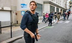 John Krasinski in Amazon Prime’s Jack Ryan, holding his gun with his finger on the trigger in a street full of civilians