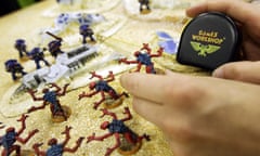 A customer plays a game of Warhammer in a Games Workshop store.