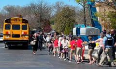 Children from The Covenant School, a private Christian school in Nashville, Tenn., hold hands as they are taken to a reunification site at the Woodmont Baptist Church after a deadly shooting at their school on Monday, March 27, 2023. (AP Photo/Jonathan Mattise)