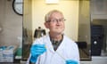 Prof Andrew Cunningham inside a lab at London Zoo wearing a lab coat and glasses