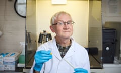 Prof Andrew Cunningham inside a lab at London Zoo wearing a lab coat and glasses