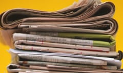 Pile of folded newspapers, front view.