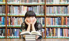 Woman daydreaming in library