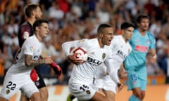 Rodrigo heads back to the centre circle with the ball after equalising for Valencia, who spurned later chances to win the match.