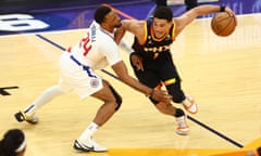 Suns guard Devin Booker (1) moves the ball against Clippers guard Norman Powell (24) during the second half of Tuesday’s game.