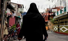 Woman in burqa walking down a street in Colombo, Sri Lanka