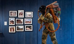 Refugee Astronaut III by Yinka Shonibare stands next to a series of photographs by Adam Chodzko