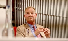 Rupert Lowe seated at a press conference table