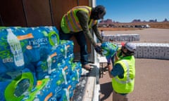 US-HEALTH-VIRUS-NAVAJO-WATER<br>Navajo Indians line up in their vehicles to collect water and supplies from a distribution point, as the Covid-19 virus spreads through the Navajo Nation, in Monument Valley at the Utah and Arizona border, May 21, 2020. - According to the Centers for Disease Control and Prevention, “Washing your hands is easy, and it’s one of the most effective ways to prevent the spread of germs,” advice it has relentlessly emphasized over the course of the coronavirus pandemic. That’s just not possible for an estimated 30 to 40 percent of this sovereign territory’s 178,000 residents, who don’t have access to running water or sanitation. This is seen as a major reason behind the surge in COVID-19 cases in the United States’ largest Native American reservation, with nearly 5,000 confirmed infections and 160 deaths at one of the highest per capita fatality rates in the country. (Photo by Mark RALSTON / AFP) (Photo by MARK RALSTON/AFP via Getty Images)