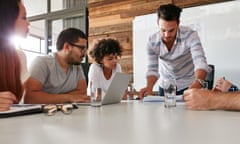 Young man presenting his ideas to colleagues during meeting in conference room