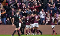 Hearts’ Lawrence Shankland (centre right) is mobbed by his teammates after scoring the second goal against Celtic.