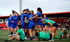 France's Agathe Sochat celebrates scoring a try with her teammates.