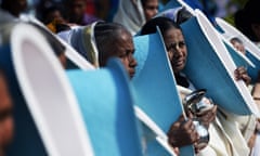 Indian women hold toilets as they participate in the opening ceremony of the three-day International Toilet Festival in New Delhi.