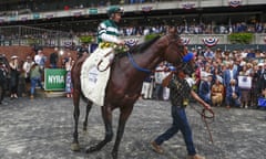 Flightline is led into the winner's circle after winning ar Belmont Park in June.