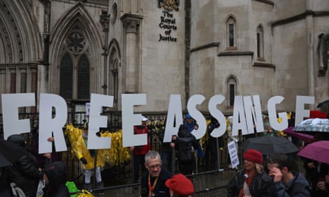Protesters hold placards spelling out 'Free Assange' in front of the Royal Courts of Justice