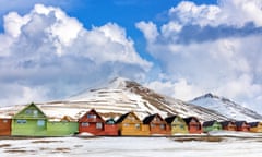 Row of colourful wooden houses in a snowy landscape