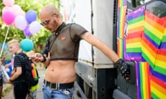 SLOVENIA-GAY-PRIDE<br>A man checks his cellphone as he takes part in Ljubljana Gay Pride Parade in Ljubljana, on June 13, 2015. Over a thousand people marched on June 13 at Slovenia’s 15th Gay Pride festival warning their fight was not over since a recently adopted bill legalising same-sex marriages could still be revoked at a referendum. AFP PHOTO / JURE MAKOVEC (Photo credit should read Jure Makovec/AFP/Getty Images)
