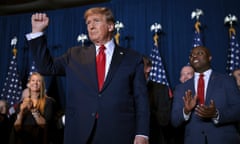 Donald Trump raises a fist as he stands on stage. Photograph: Win McNamee/Getty Images