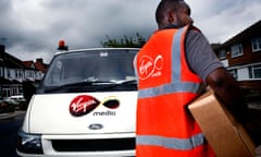 A Virgin Media employee delivering a digital TV receiver.