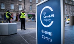 Police officers outside the main entrance to the UK Covid-19 Inquiry hearing.