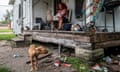 a woman sits on her front porch