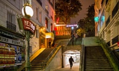 Stairs beside an entrance to the metro in Montmartre at night