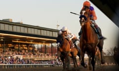 Authentic, ridden by John Velazquez, crosses the finishing line to win the Breeders’ Cup Classic from Improbable at Lexington on Saturday.