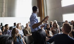 Professor giving lecture among auditorium audience<br>EYN565 Professor giving lecture among auditorium audience