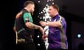 Michael Smith (left) embraces Luke Littler as he celebrates victory in the Premier League semi-final.