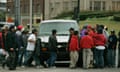 Men surround a truck looking for work.