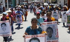 Women and men holding signs of loved ones on protest march