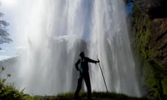 Kevin Rushby standing behind Kiki waterfall.