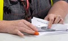 A woman counting postal votes