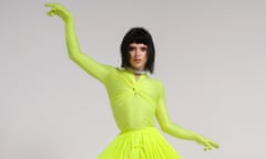 Bimini standing on a podium wearing a fluorescent green jumpsuit