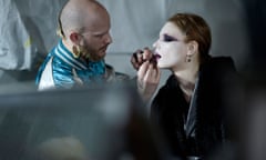 A model preparing for the runway during Paris Fashion Week